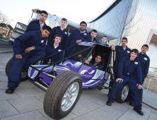 Automotive students with grassracer outside college