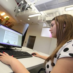 Female student sitting at computer desk