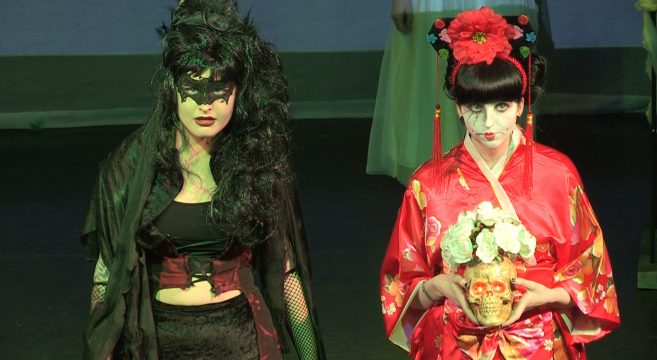 Hair show models on catwalk in gothic black mask and red kimono