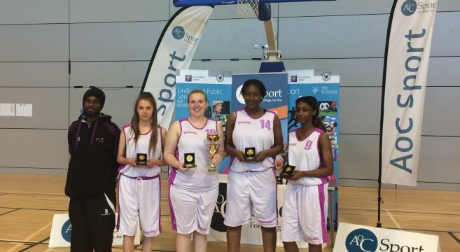 Ladies' basketball team holding their awards
