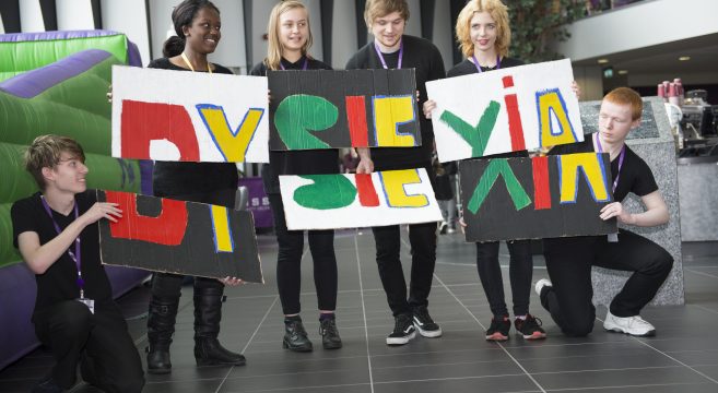 Students holding dyslexia day signs