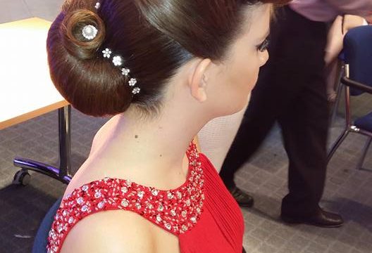 Female student in red dress modelling a hair up style