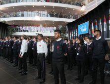 Rows of students in uniform in atrium