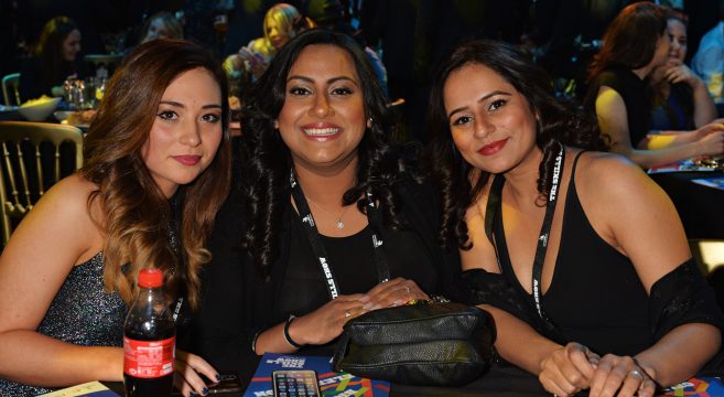 Three adult students at awards dinner table