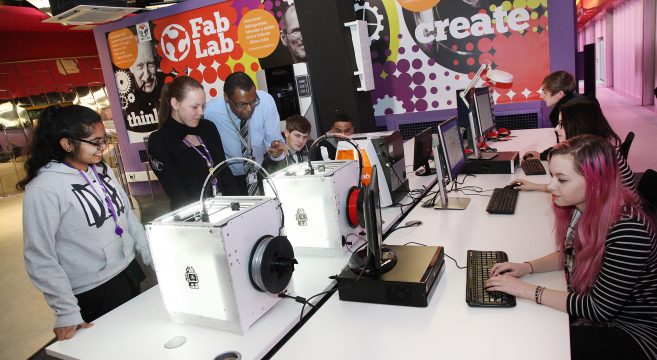 Lecturer teaching students about 3D printers at Fab Lab