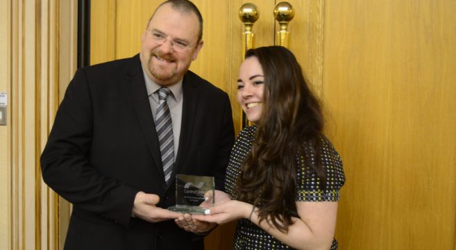 Council leader presenting award to female student