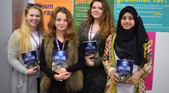 Four female students holding books