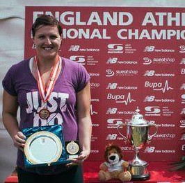 Female athlete wearing medal and holding plate