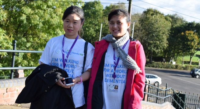 Two female students wearing charity t-shirts