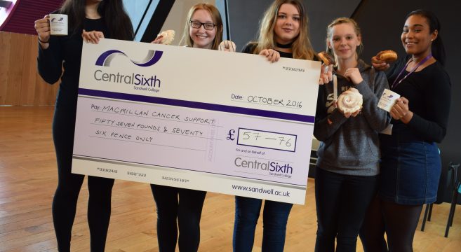 Students holding giant cheque