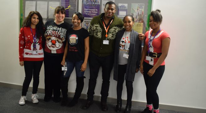 Group of staff members wearing their Christmas jumpers