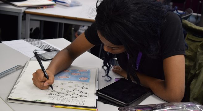 Student drawing a bag design