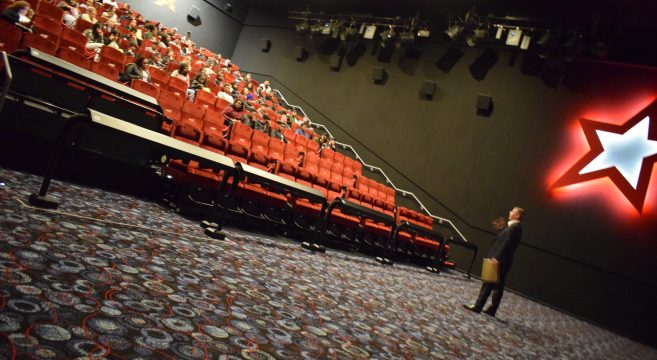 Teacher in lecture hall giving seminar to students