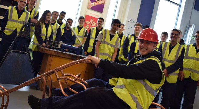 Student sat on copper bike