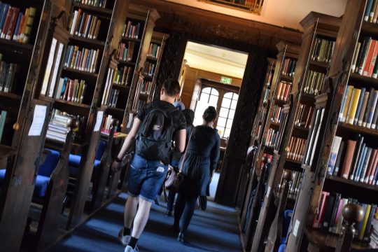 Students walking through library at Oxford University