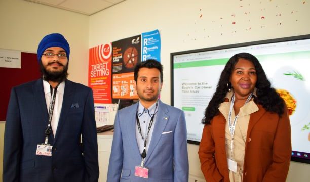 Two male computing students with female employer