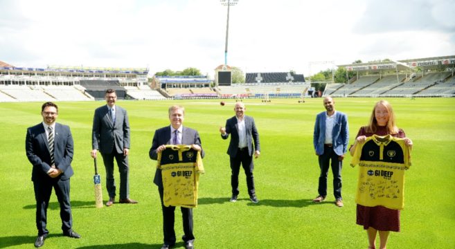 College and club managers holding signed shirts at Edgbaston cricket ground
