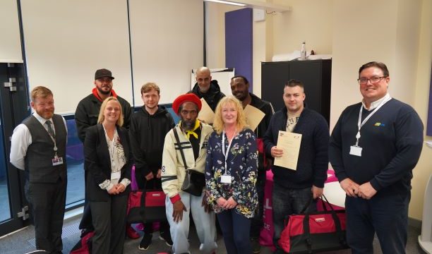 Adult construction learners with their certificates