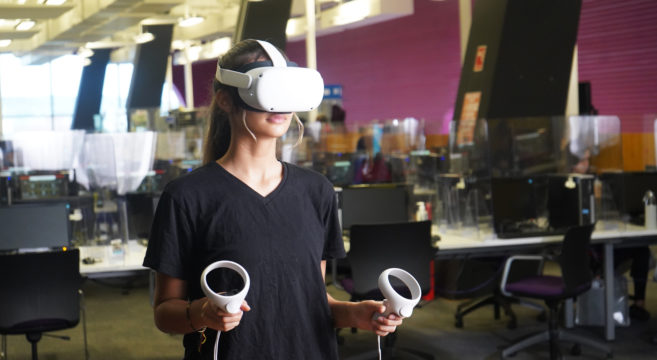 A female student using VR equipment
