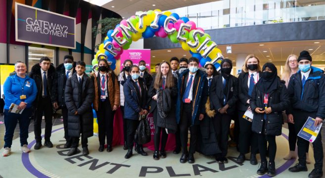 School pupils stand under the Apprenticeships balloon arch