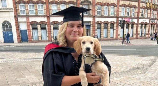 student graduating with dog