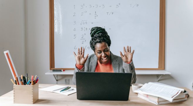 lady with hands up in the air and maths in the background