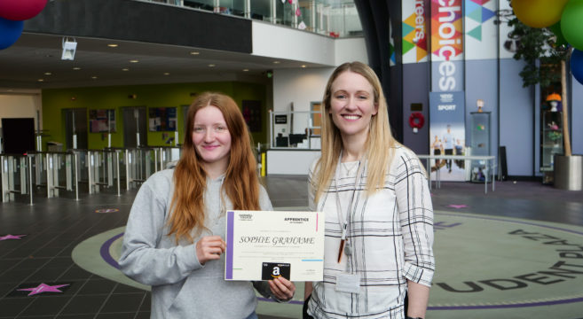 Apprentice Sophie Grahame being presented with her award by manager