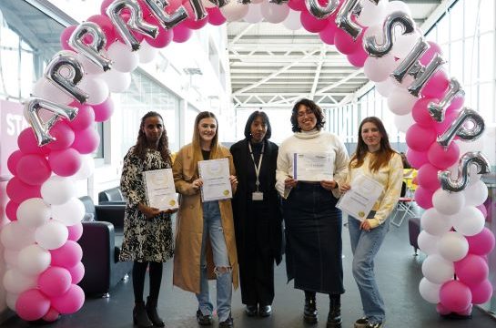 Star Apprentices standing together under a balloon arch