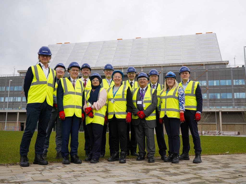 Stakeholders of the new Midland Met Hospital standing in front of the site