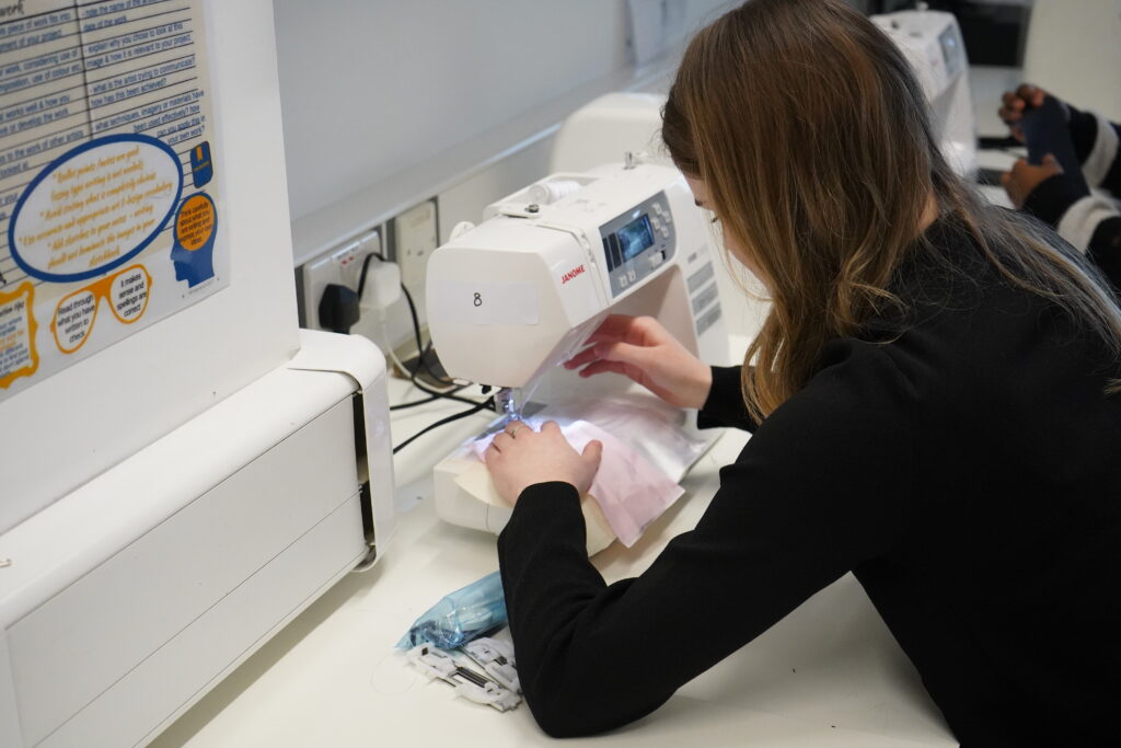 Sandwell College Fashion student with sewing machine