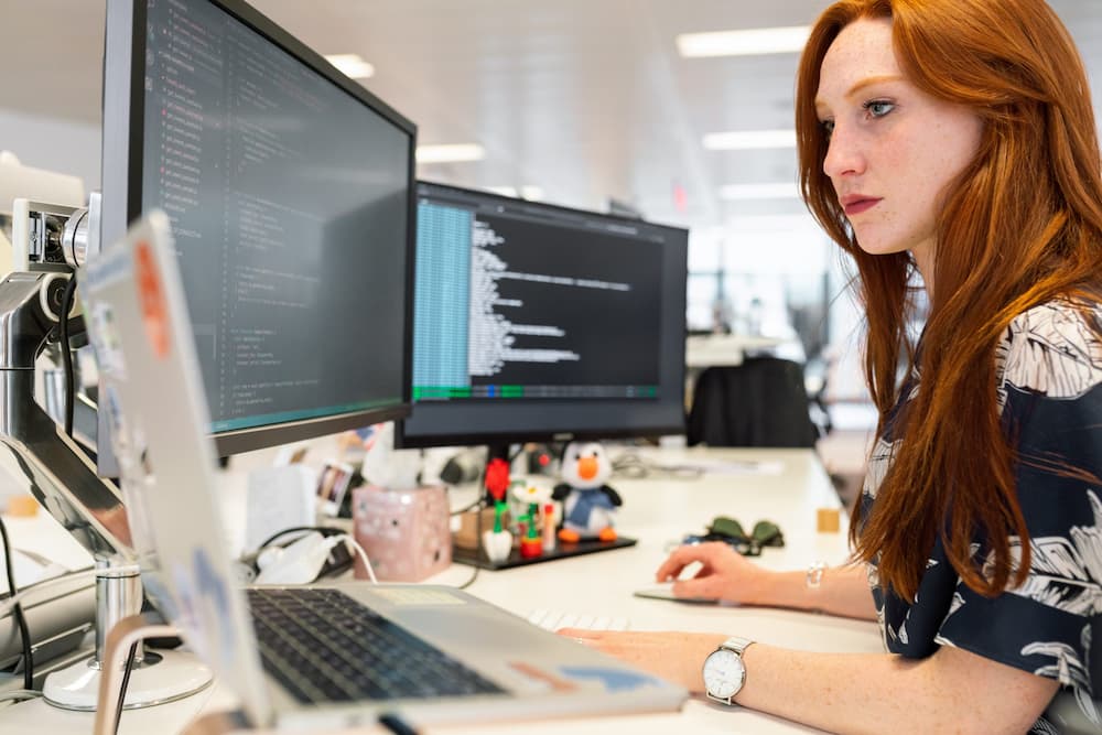 Female office worker working on computers