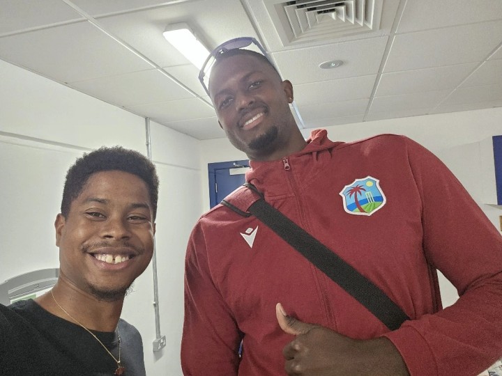 Former student Derron with WI cricketer Jason Holder