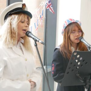 Students signing at VE Day Celebration