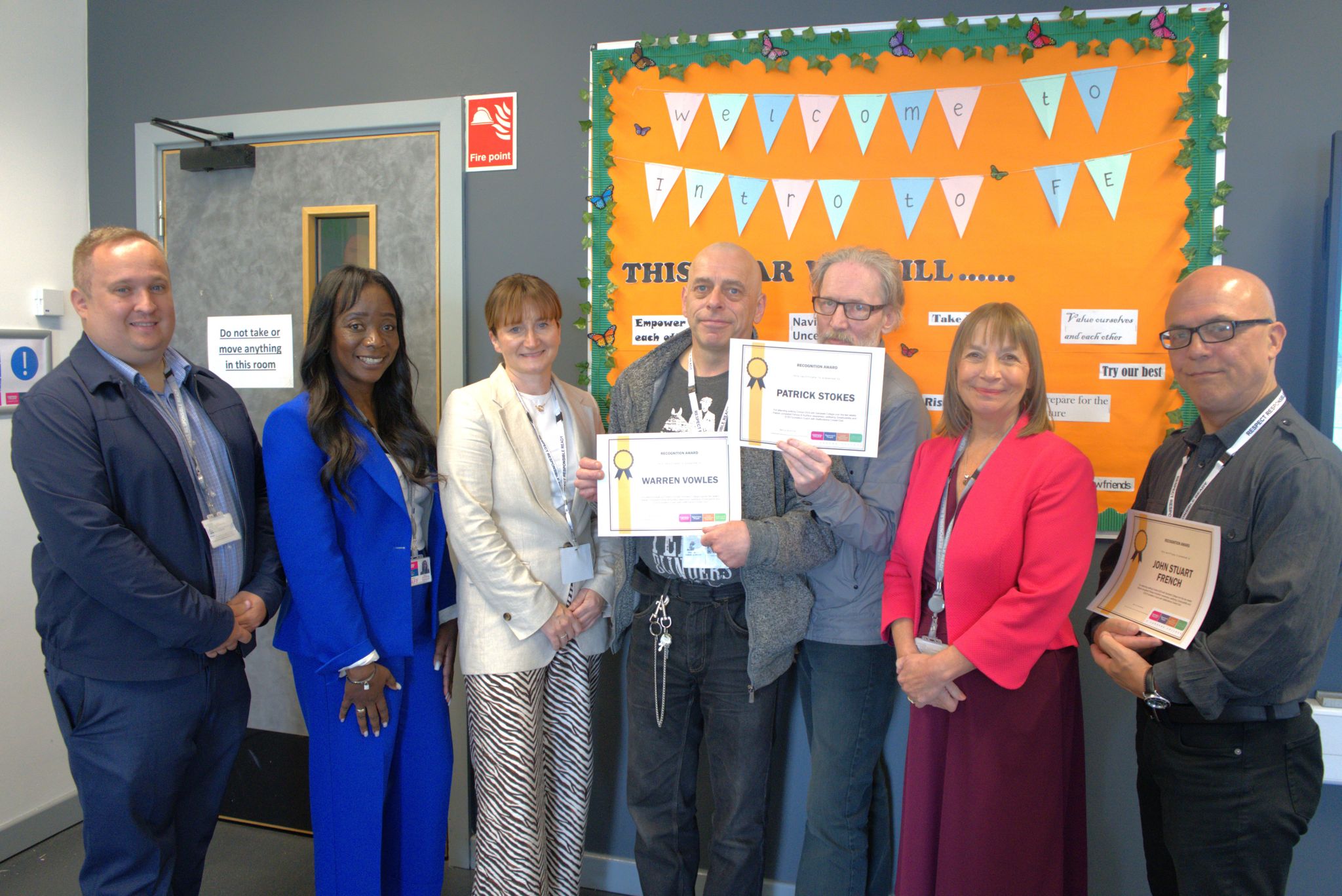 Over 50s SWAP cohort smiling with their certificates plus staff