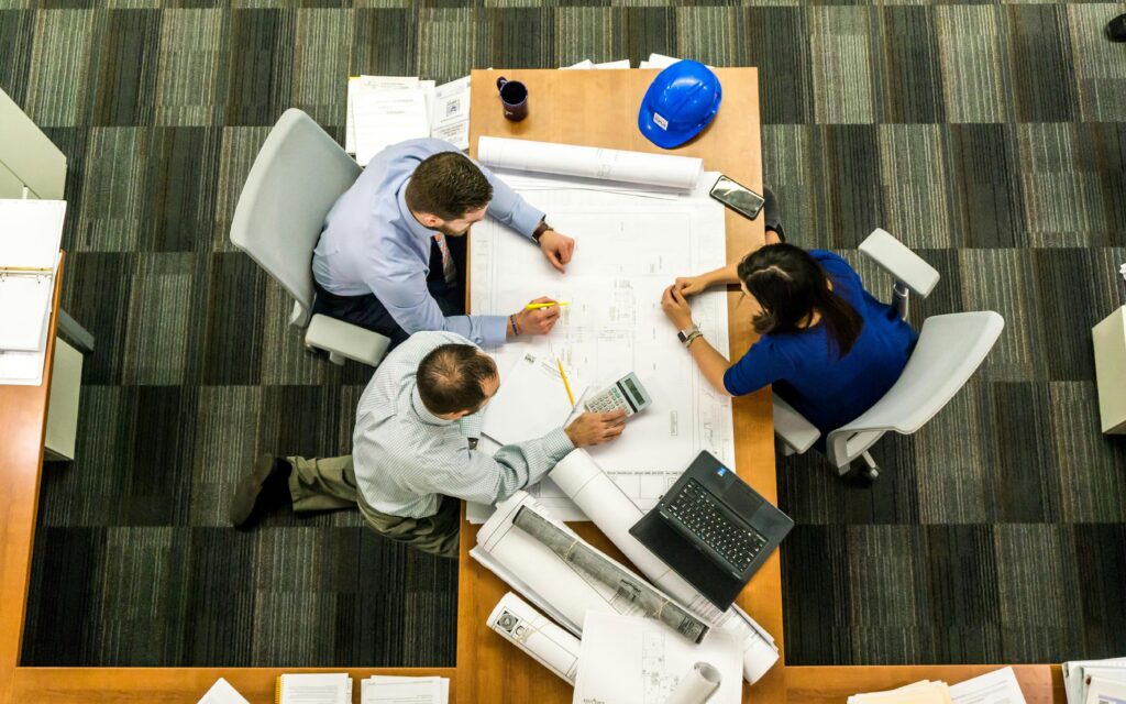 3 people around a meeting desk