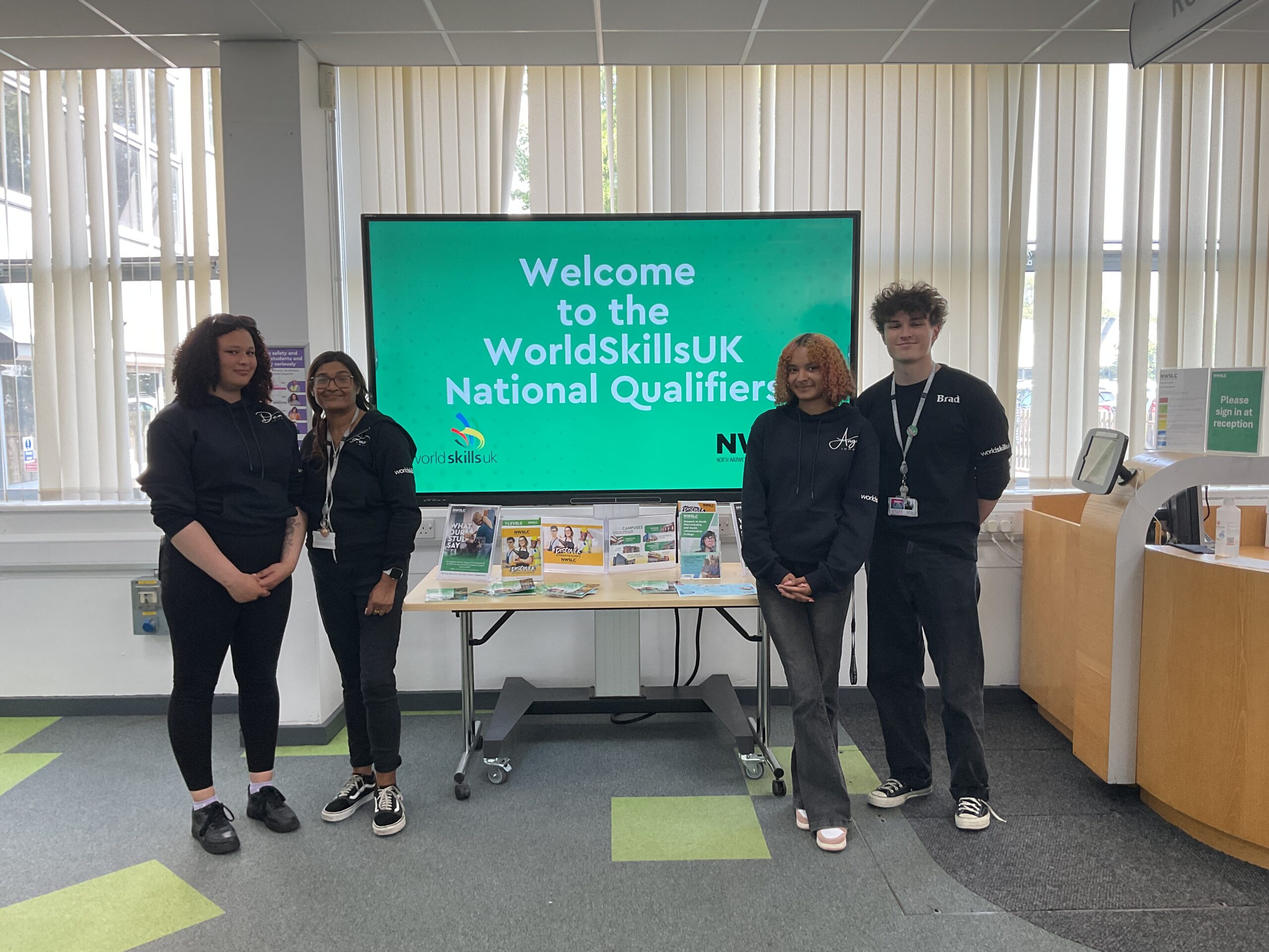 Foundation Learning students at WorldSkills qualifiers with a board in the background