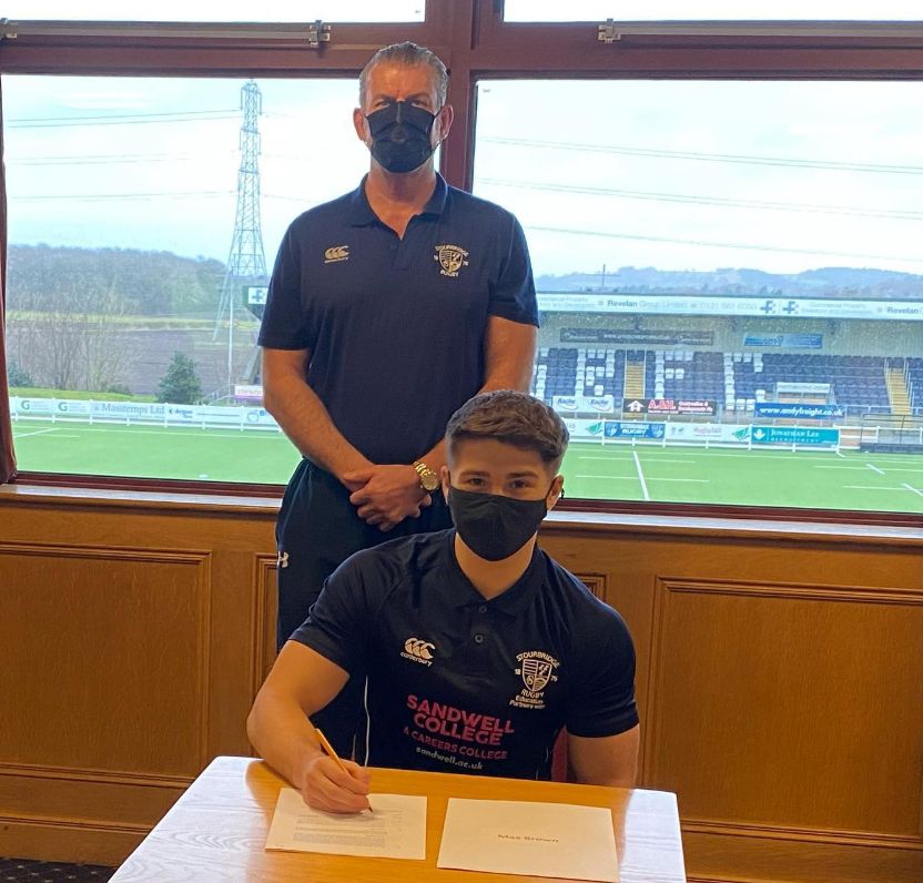 Max Brown Alumni signing a contract