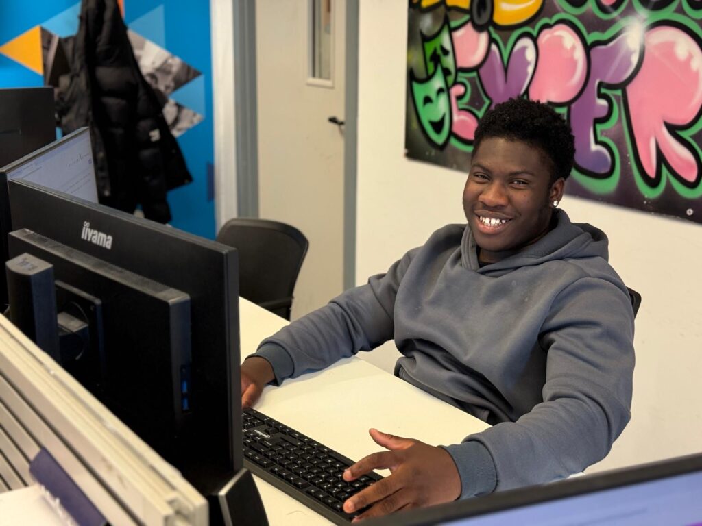 Business Administration apprentice sitting at his desk