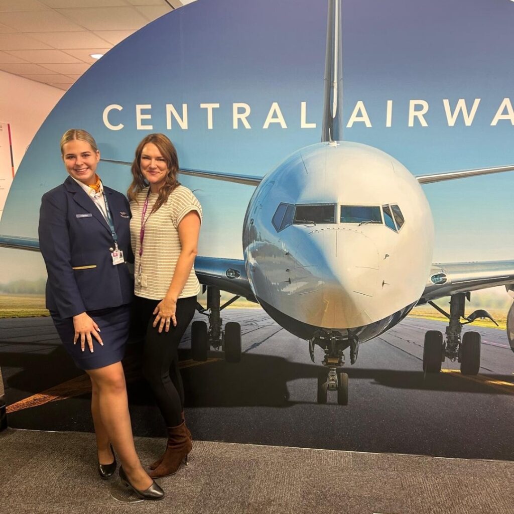 Travel student in cabin crew uniform with lecturer