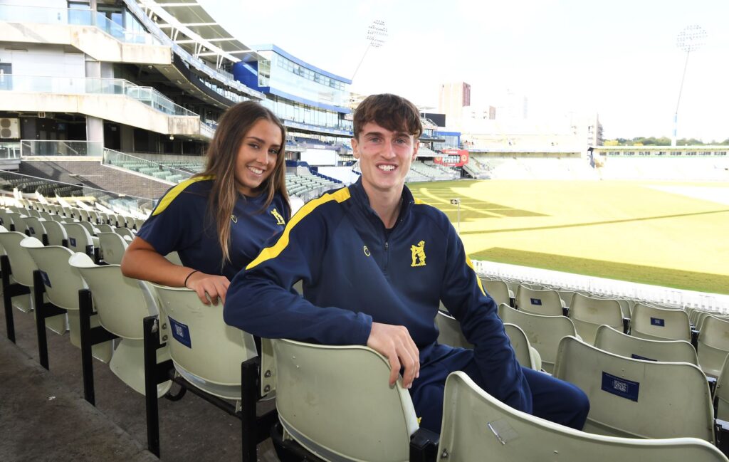 Sandwell College cricket alumni Olivia and Blake sitting at Edgbaston Stadium