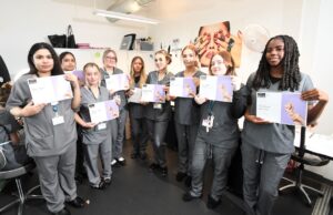 Beauty students holding certificates