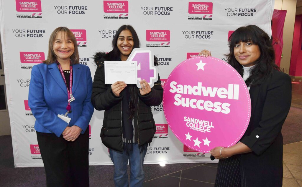 Student holding exam results with principal and head of department