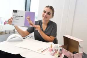 Beauty student holding certificate
