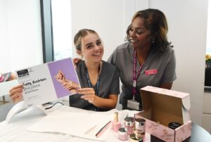 Beauty student and lecturer with certificate