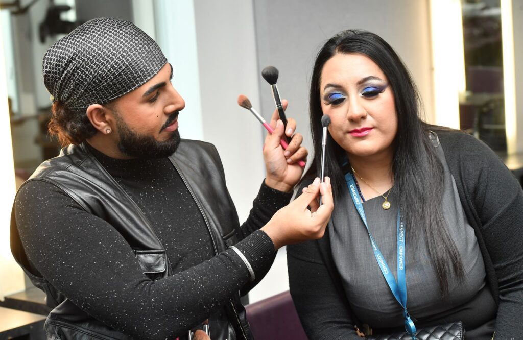 BBC Glow Up make-up artist Rahual Das demonstrates brush techniques on student