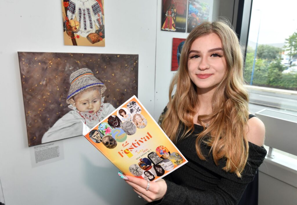 Art student holding Festival of Arts brochure